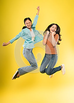 two happy women jumping and laughing happily