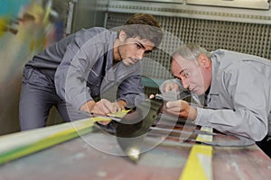 Two happy workmen toiling at locksmiths workshop