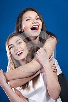 Two happy young beautiful woman friends