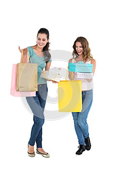 Two happy young female friends with shopping bags