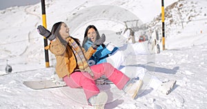 Two happy young women enjoying a winter holiday