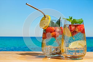 Two hard seltzer cocktails on summer beach.