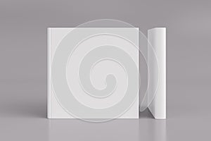 Two hardcover  square white mockup books standing on the white background. Blank front cover and spine of book