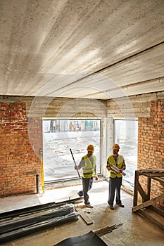 two hardworking men in safety vests