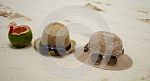 Two Hats and sunglasses on one coco nut cocktails