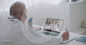 Two health professionals are communication online by videoconference service, young woman is listening experienced