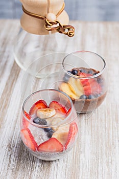 Two healthy fruits dessert on a wooden table