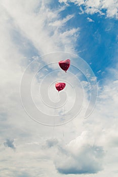 Two heart-shaped balloons