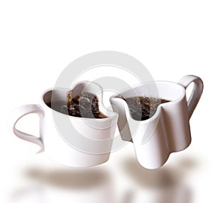 Two heart shaped love cups of coffee levitating photo