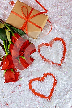 Two heart shapes and beautiful red roses with gift box on white background
