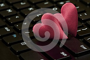 Two hearts on the black computer keyboard