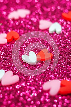 Two Hearts candy confetti on purple sparkle background. Valentines day macro wallpaper. Holiday love card