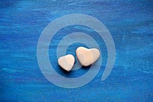 Two hearts candy jelly beans valentine`s blue backg photo
