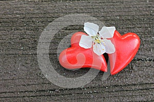 Two hearts with cherry blossom on wood