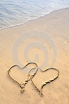 Two hearts drawn in beach