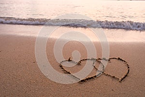 Two hearts drawn in beach