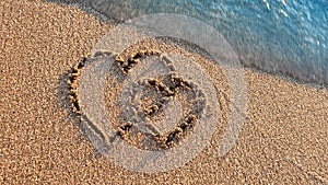 Two hearts drawn on brown sand of paradise beach