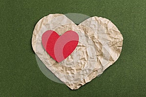 Two hearts on a green background. Valentine`s Day. Paper hearts