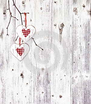 Two hearts, hanging on a branch