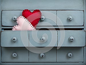 Two hearts inside a drawer in a dresser