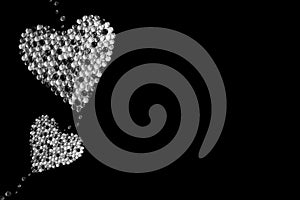 Two hearts made of stones isolated on black background. Black and white image. Poem background. Valentine\'s Day. Christmas