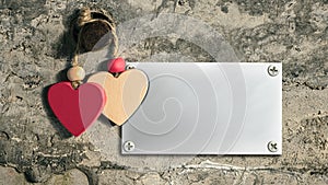 Two hearts on an old concrete wall. Metal plate for text. Mockup. Valentine`s Day.