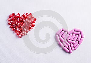 Two hearts, pomegranats heart vs pills heart. Choosing between medicine pills and natural treatment. Making decision between