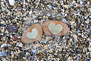 Two Hearts on Red Rocks on Sand