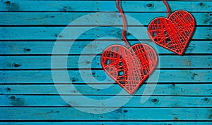 Two Hearts On Rustic Wood Blue Background. Heart Shape made By red thread hang with ropes in wooden wall, Original Love Concept