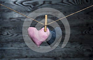 Two hearts together on wooden background