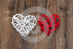 Two hearts on the wooden background, red and white heart