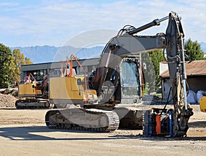 Two heavy excavators in the construction site during a redevelopment work.