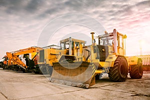 Two heavy wheeled tractor one excavator and other