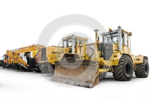 Two heavy wheeled tractor one excavator and other construction machinery isolated on white