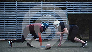 Two helmeted football players