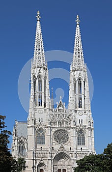 Two white bell towers of the VOTIVE CHURCH in Wien in Austria In Central Europe