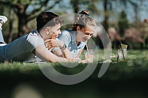 High school students collaborating on a project outdoors on a sunny day