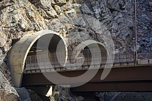 Two Highway Tunnel Entrances cut into a Mountainside photo