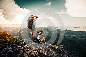 Two hikers relax on top of a mountain photo