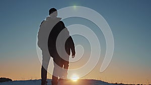 Two hikers tourists walking go on sunset top of mountain silhouette winter. teamwork travel business concept. Two people
