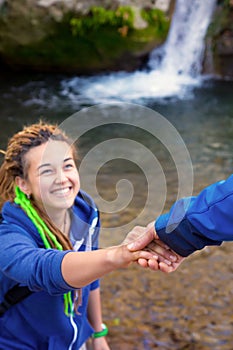 Two Hikers young Man and Smiling Woman holding hands vertical