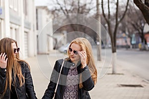 Two hipster girl friends hanging out in the city