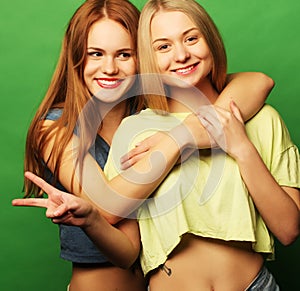Two hipster girls best friends over green background
