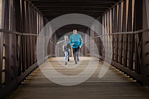 Two Hispanic Brothers Run A Race Down Bridge