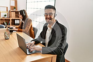 Two hispanic call center agents working at the office