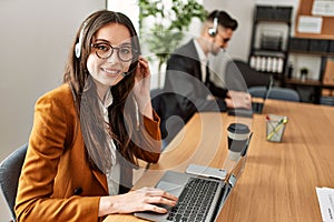 Two hispanic call center agents working at the office