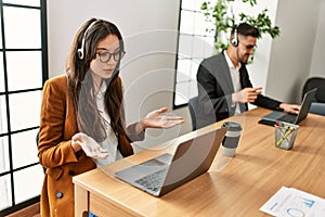 Two hispanic call center agents working at the office