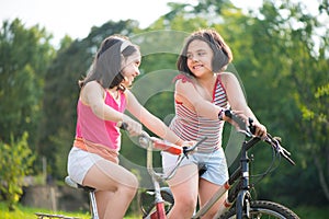 Two hispanic children riding on bikes