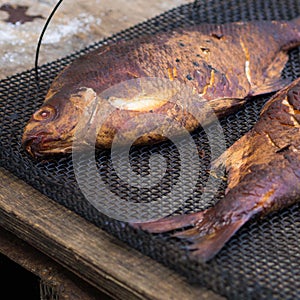 Two homemade smoked bream on a metal mesh