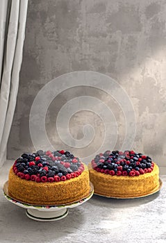 Two honey cakes with blueberries and raspberries